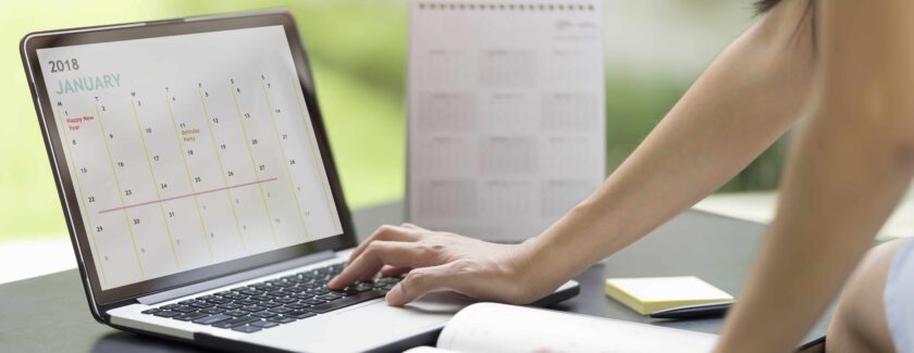 Woman planning agenda and schedule using calendar event planner. Woman hands using plan to vacation on computer laptop. Calender planner organization management remind concept.